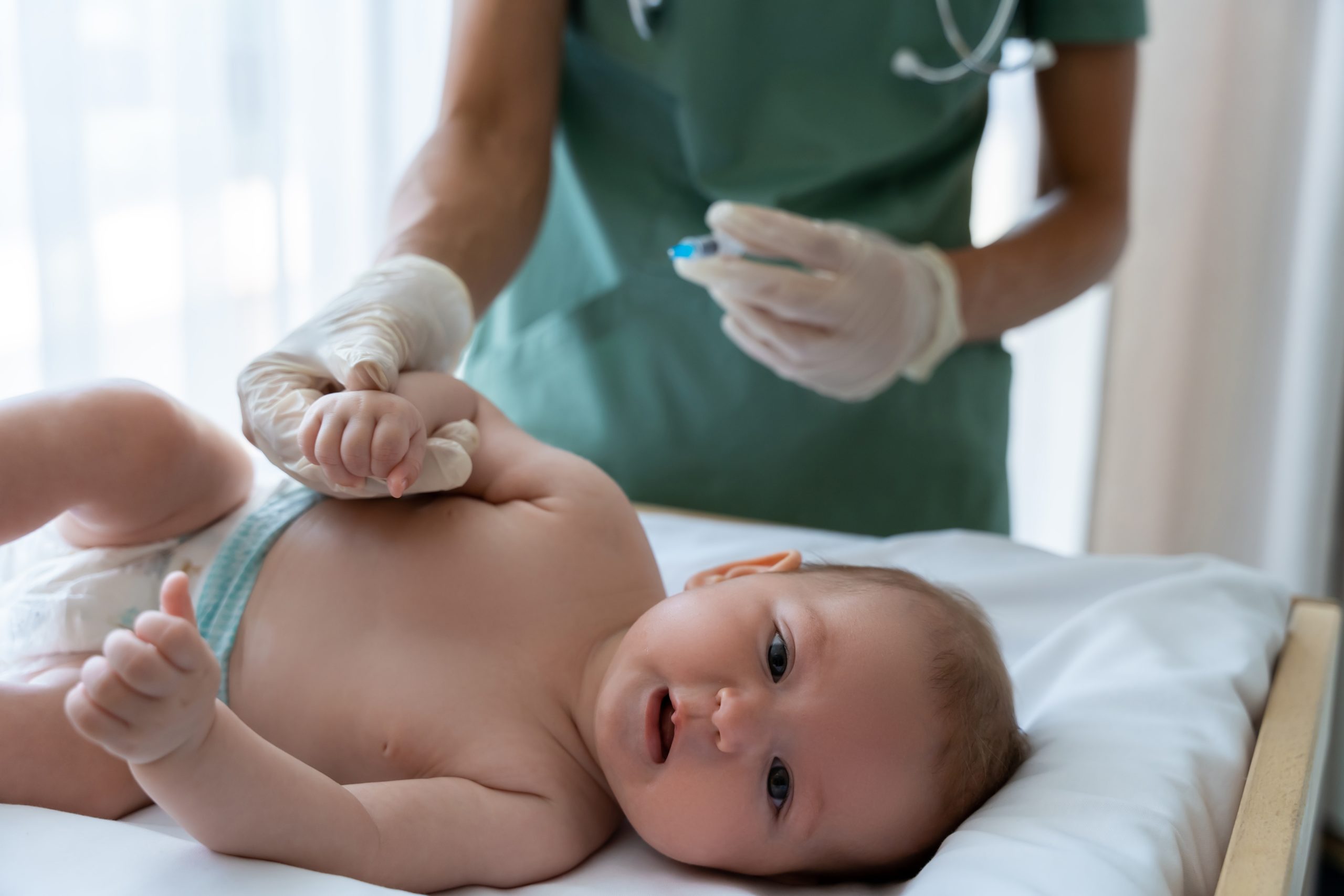 Medical,Professional,Carefully,Vaccinating,Young,Child,With,Syringe,During,Injection